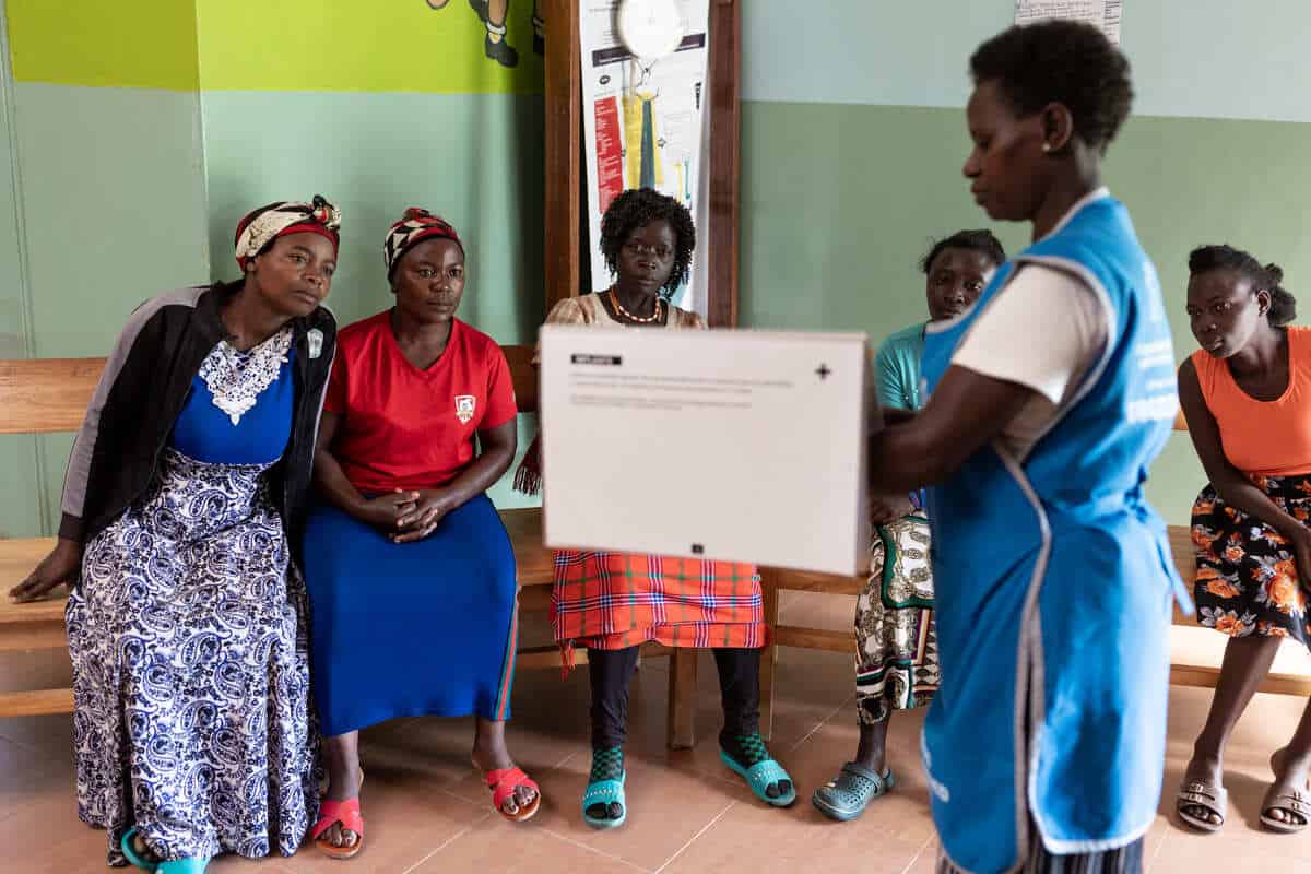 Nurse explains reproductive health services to women affected by USAID funding cuts.