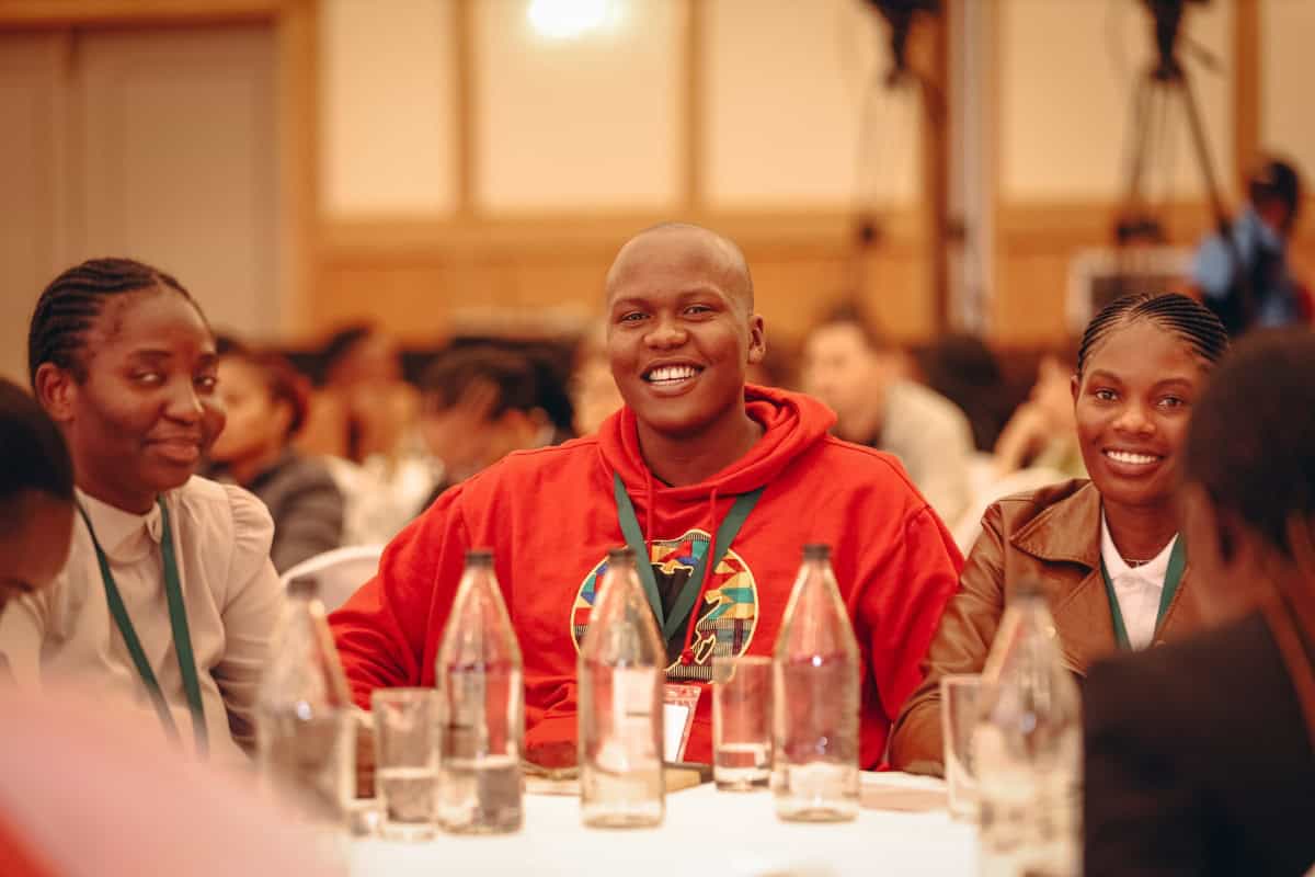 Youth smiling at Africa tourism summit.