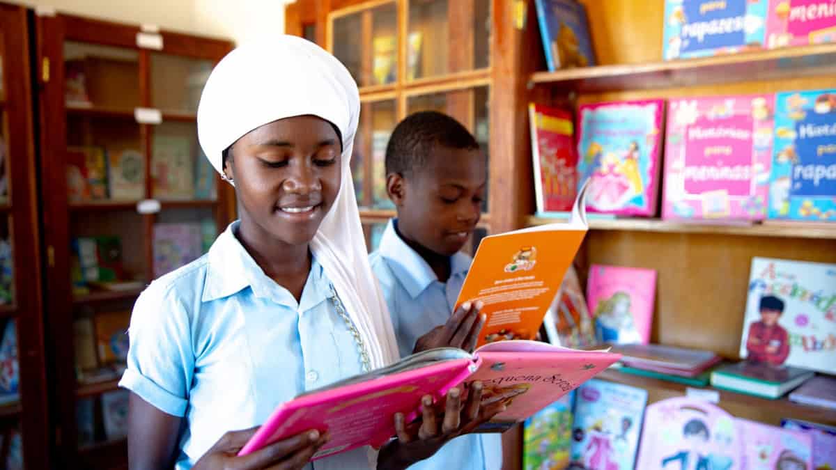 Young students reading books in a classroom supported by EU initiatives.