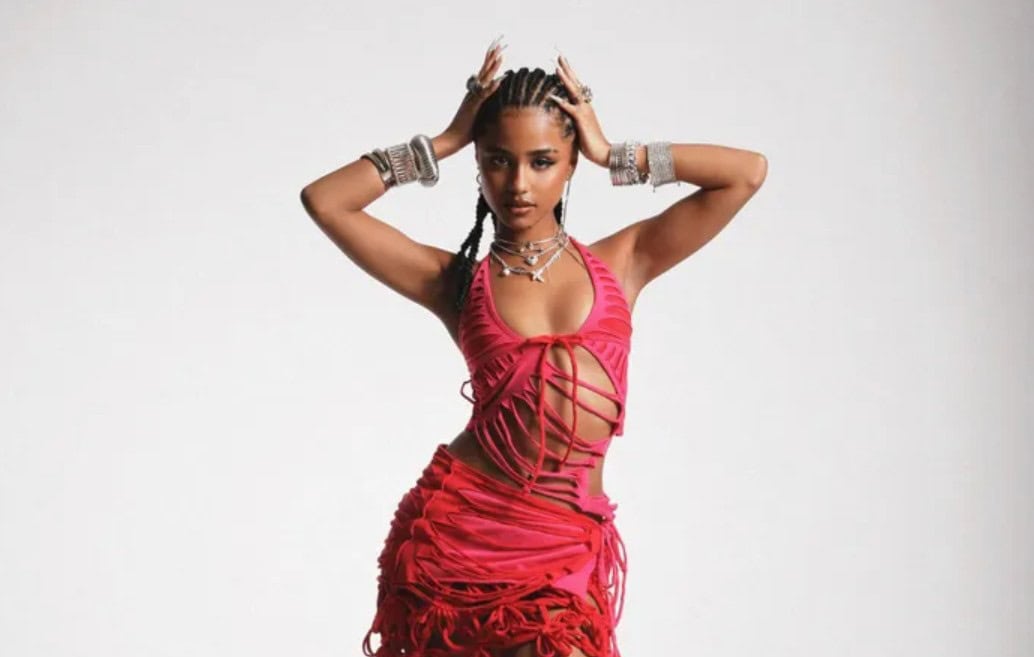 Fashion-forward woman in vibrant red outfit with jewelry, showcasing modern African style and creati.