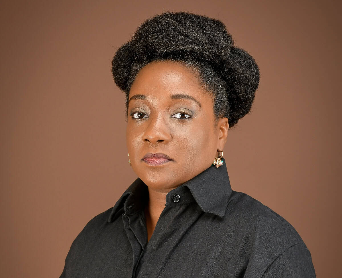 African woman professional in black shirt, discussing financial strategies for budget review.