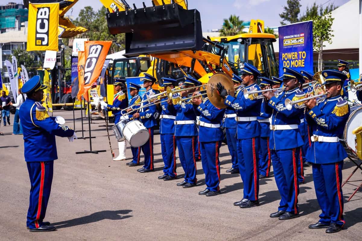 Construction equipment and military band at Ethiopia event.
