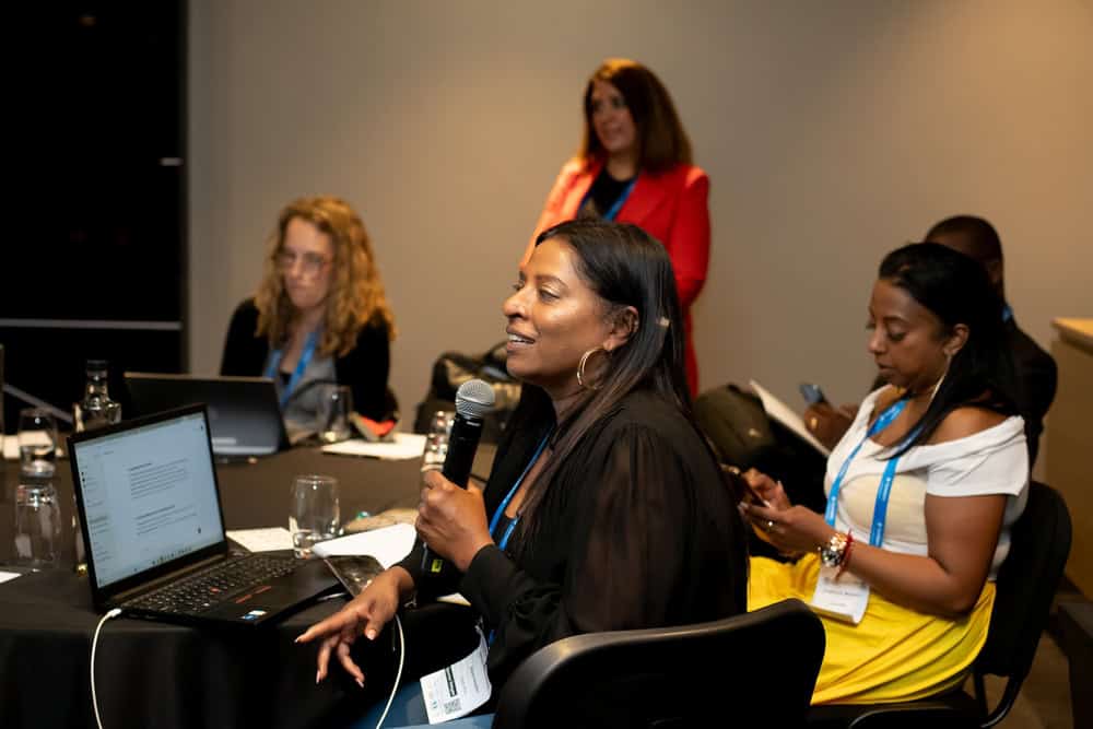Women discussing carbon markets at Africa Summit conference.