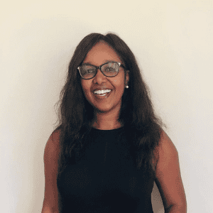 African researcher smiling, promoting health research capacity in Africa.
