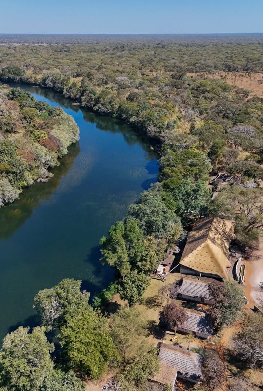 Aerial view of the Lolelunga Private Reserve showcasing lush greenery and a winding river.