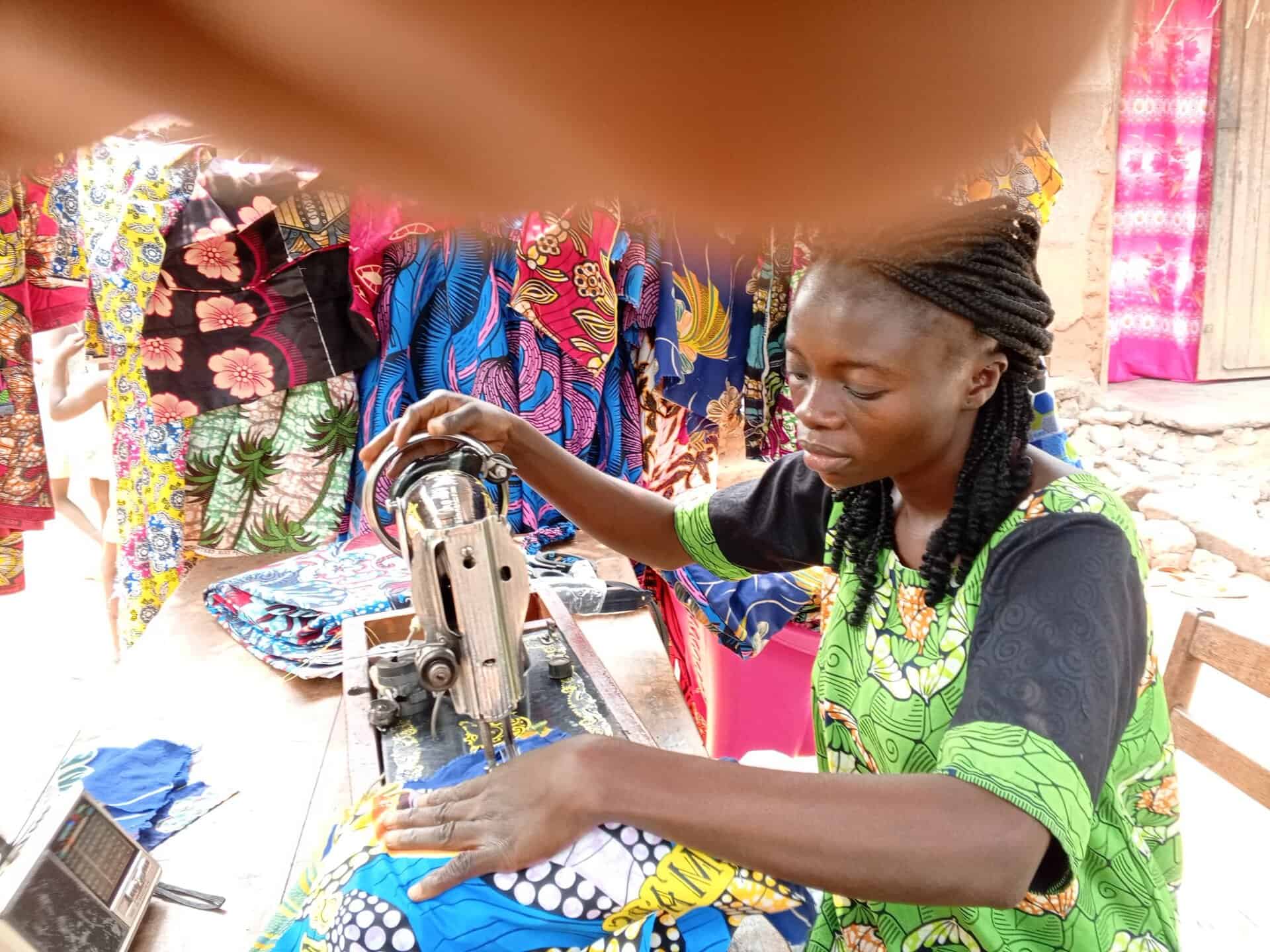 DR Congo women entrepreneurs sewing vibrant traditional fabrics.