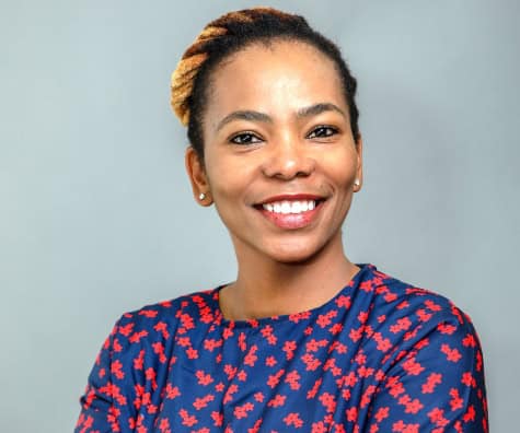 African woman smiling, showcasing confidence and positivity.