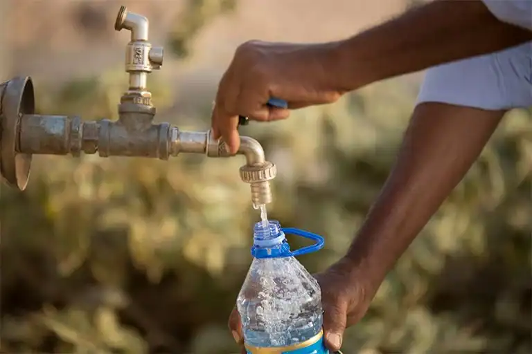 Water tap providing clean water to a bottle in South Africa.