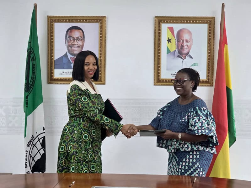 Two women shaking hands during a formal agreement in Ghana and Senegal for green jobs.