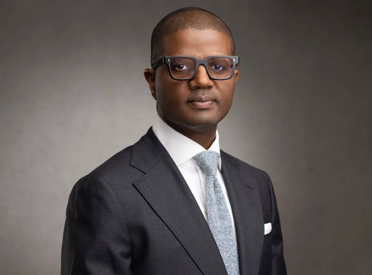 African professional in business suit and glasses.