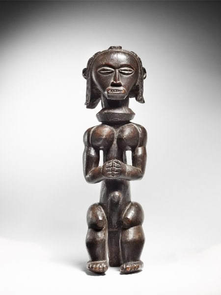 Ancient African wooden sculpture showcasing traditional art and cultural symbolism.
