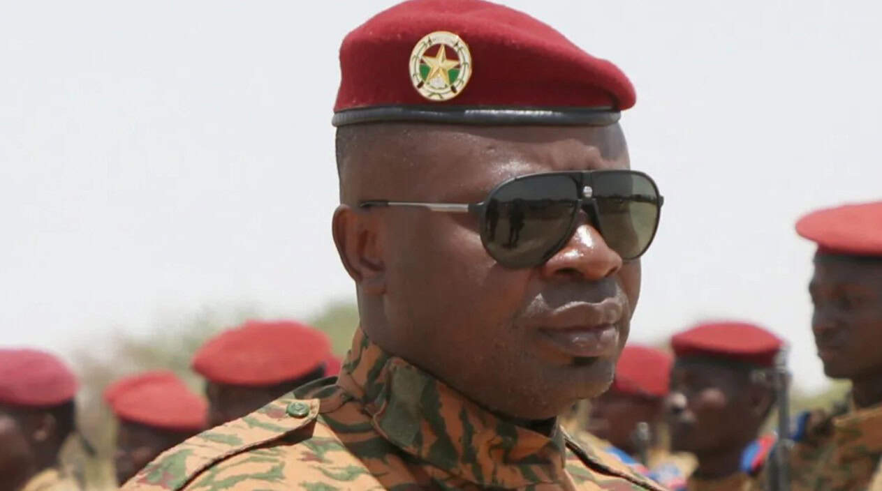 Military officer in uniform with sunglasses during a tourism event in Africa.