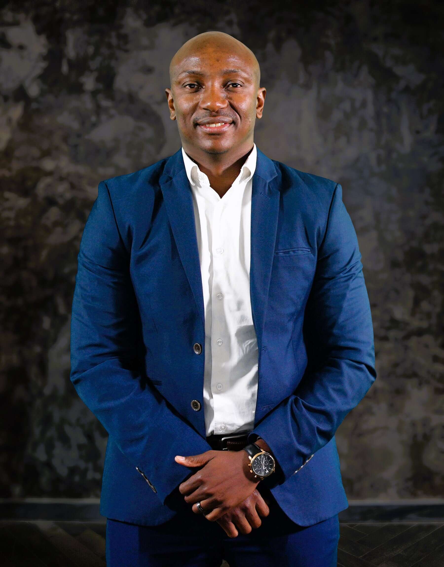 Business professional in formal attire, representing grocery and food retail sector growth.