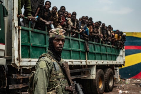 Group of civilians and soldiers in Congo, highlighting regional conflict and humanitarian concerns.