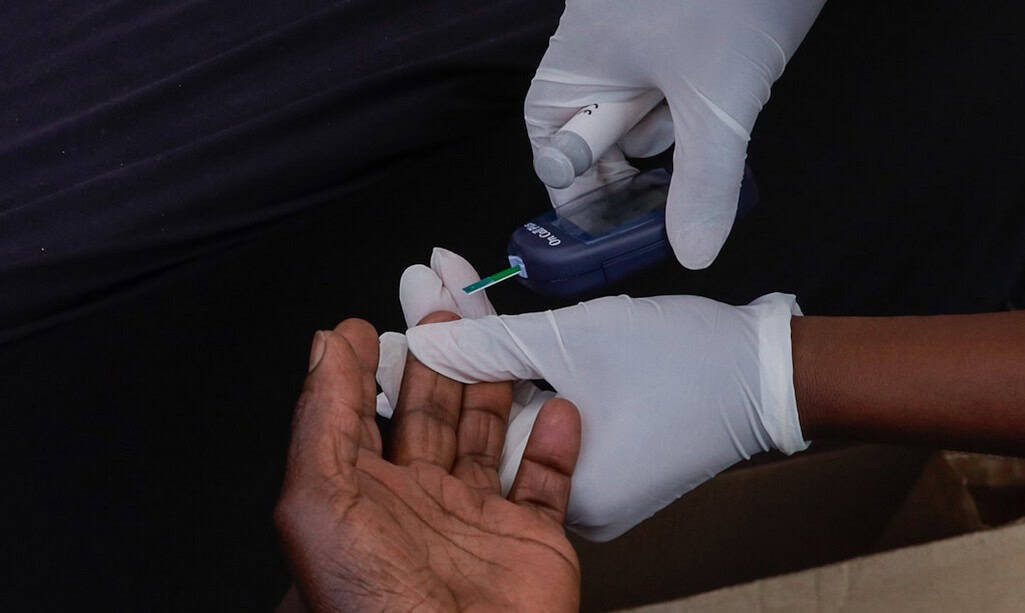 Person testing blood sugar levels for diabetes management.
