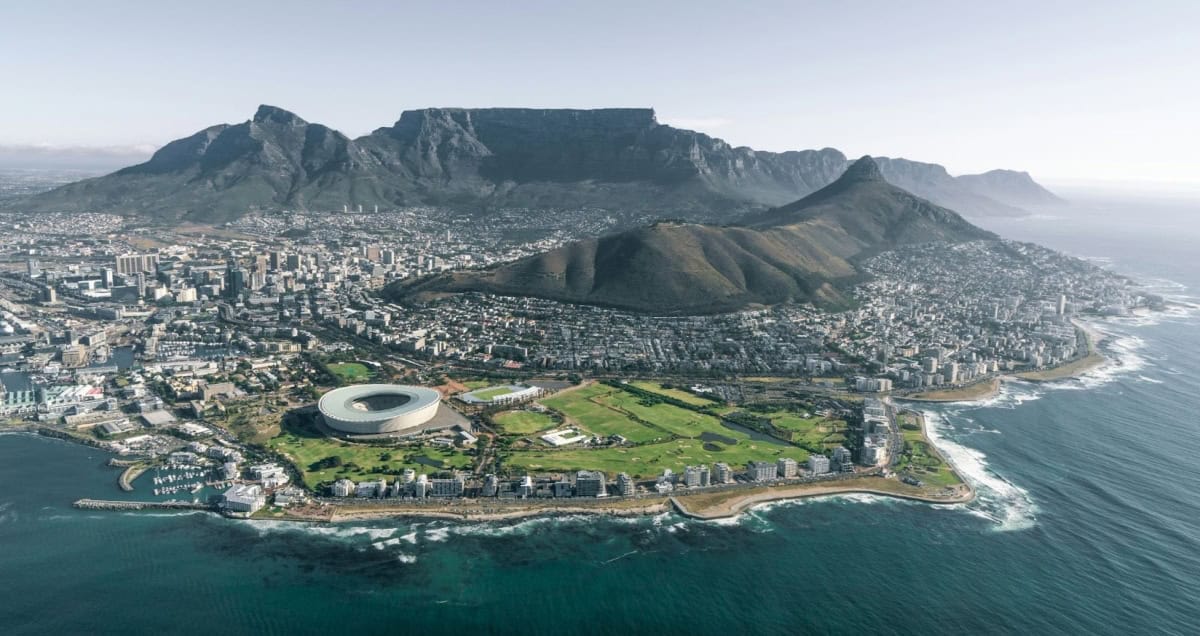Aerial view of Cape Town with Table Mountain and city skyline by the coast.