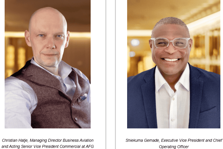 Two aviation professionals, one Caucasian and one African, in business attire at an airport.