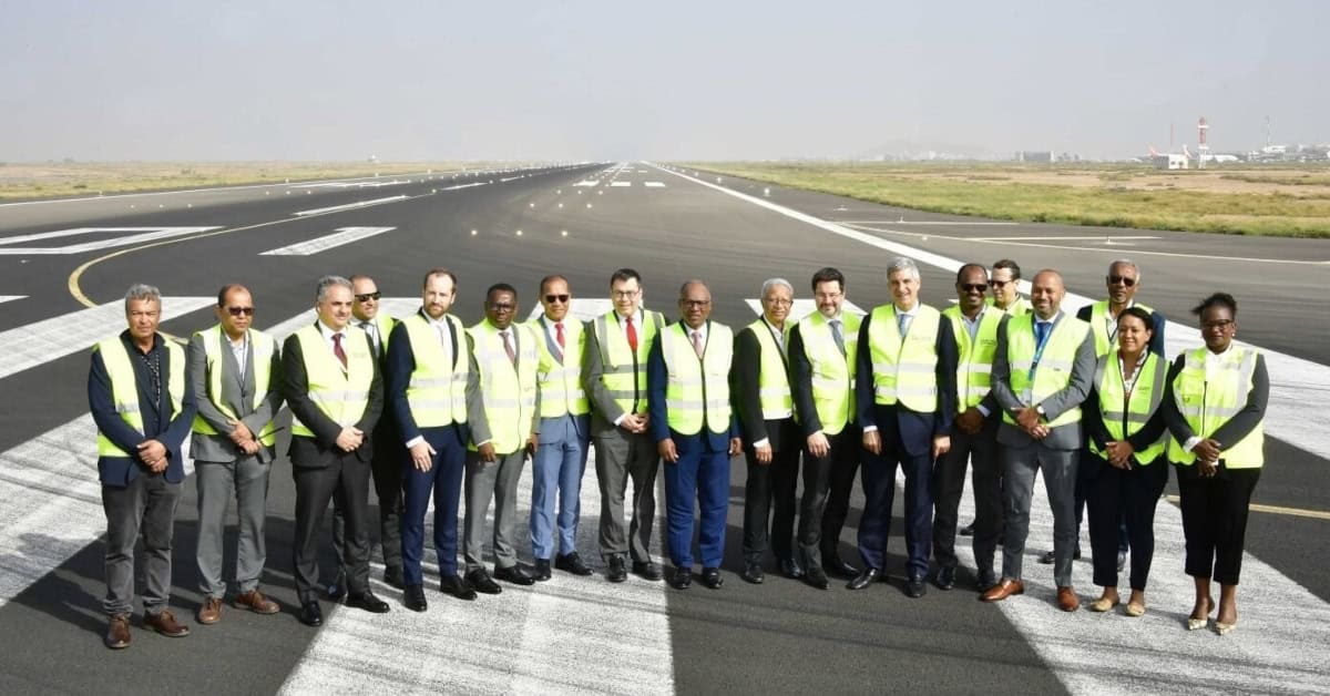 Group of professionals on an airport runway during infrastructure project.