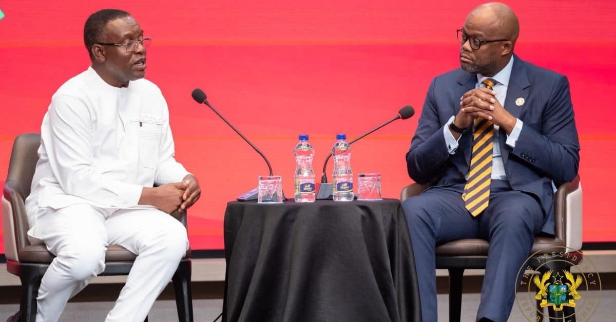Two African leaders in discussion at a conference on economic sovereignty.