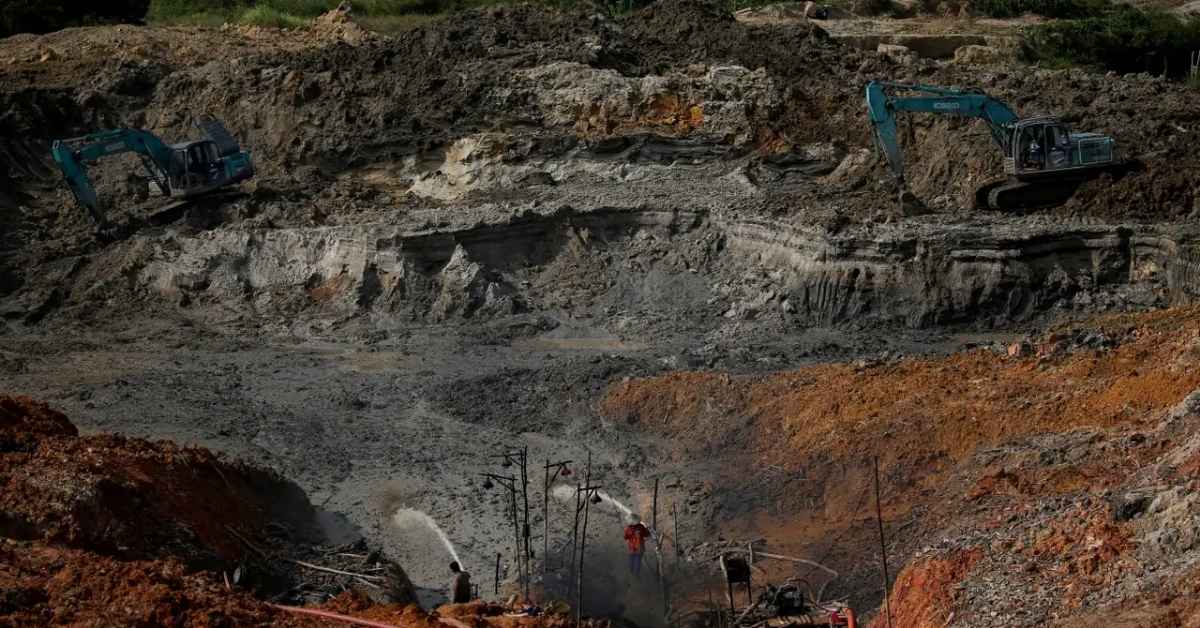 Mining excavation site with heavy machinery in an African landscape.