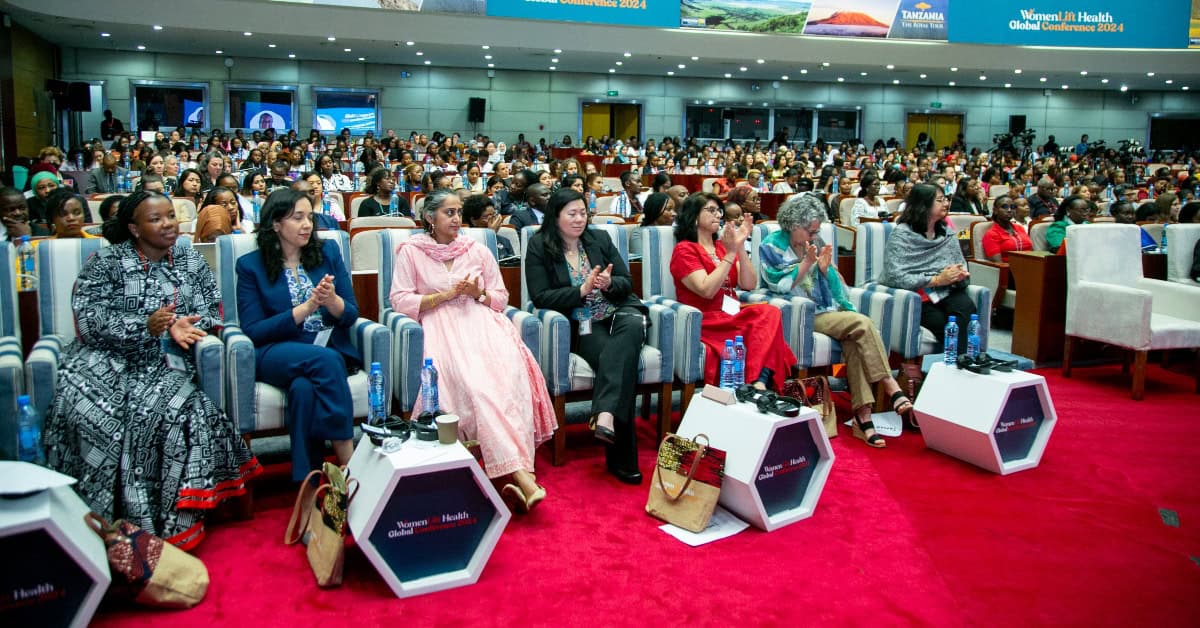 Diverse women leaders attending a conference on gender-informed health leadership.