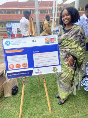 Sudanese woman showcasing digital initiative at community event.
