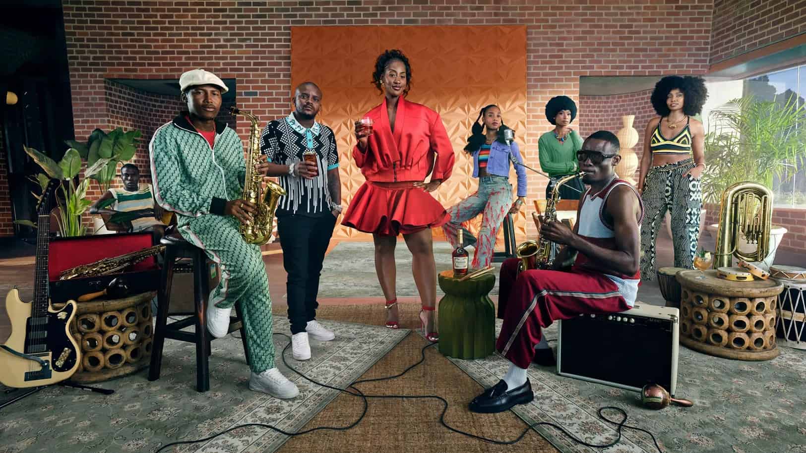 African musicians performing with traditional and modern instruments in a lively studio setting.