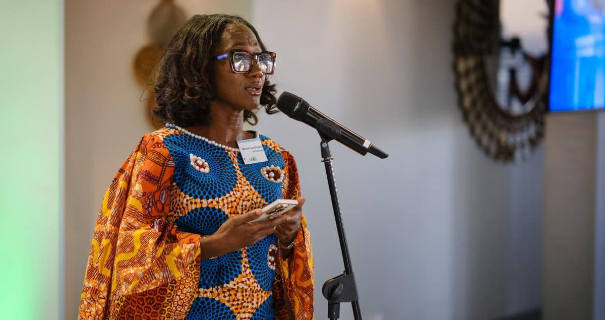 African woman speaking at a conference about local fund domiciliation.