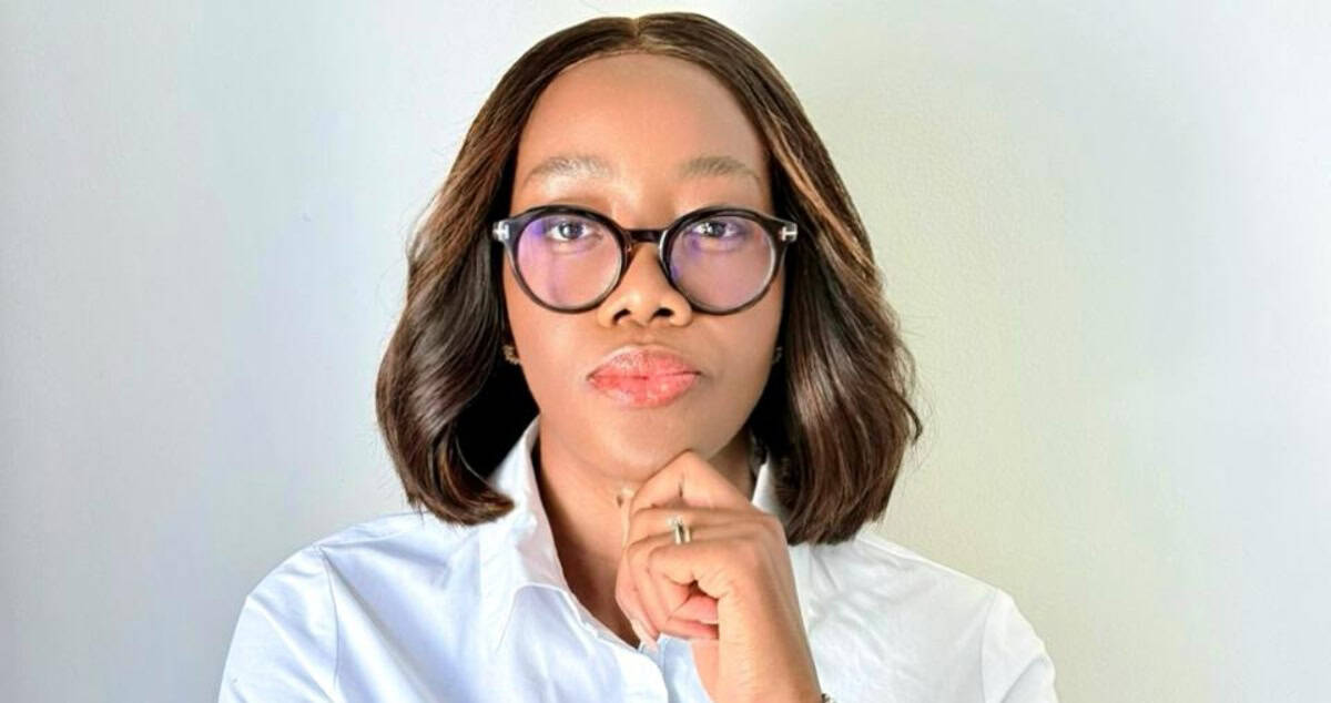 Businesswoman with glasses thinking about African market growth and leadership.