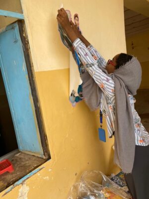 Sudanese woman creating digital content for equal access to opportunities.