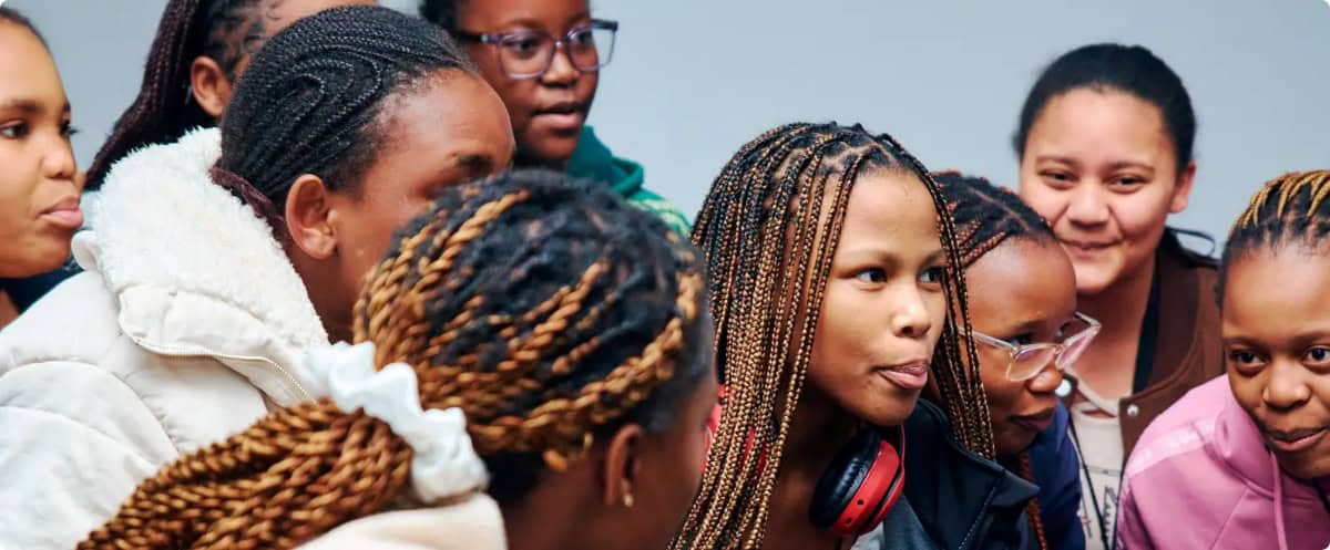 Diverse group of young African entrepreneurs engaged in a discussion.