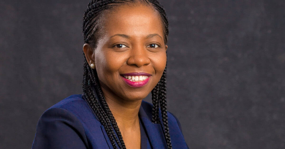 Smiling African woman advocating for girls' empowerment and safety in Africa.