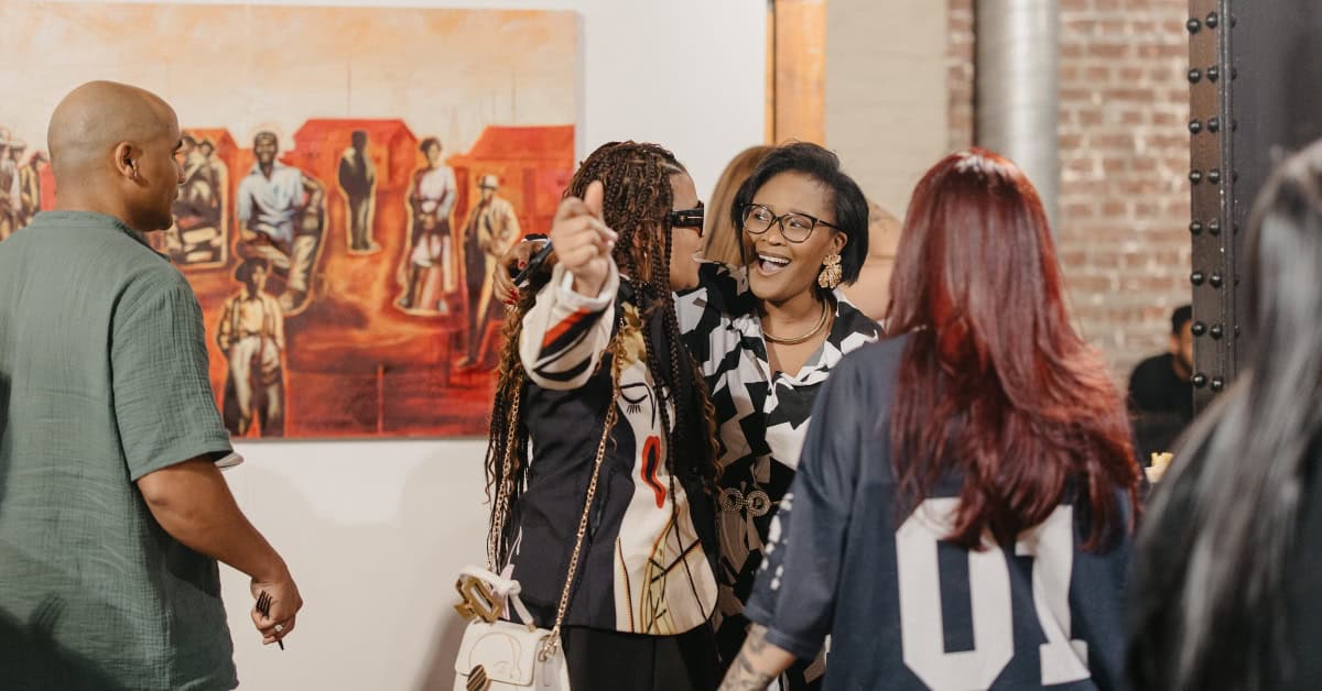 Group of diverse women engaging and discussing art at Ava Gallery during Nando’s Creative Exchange.