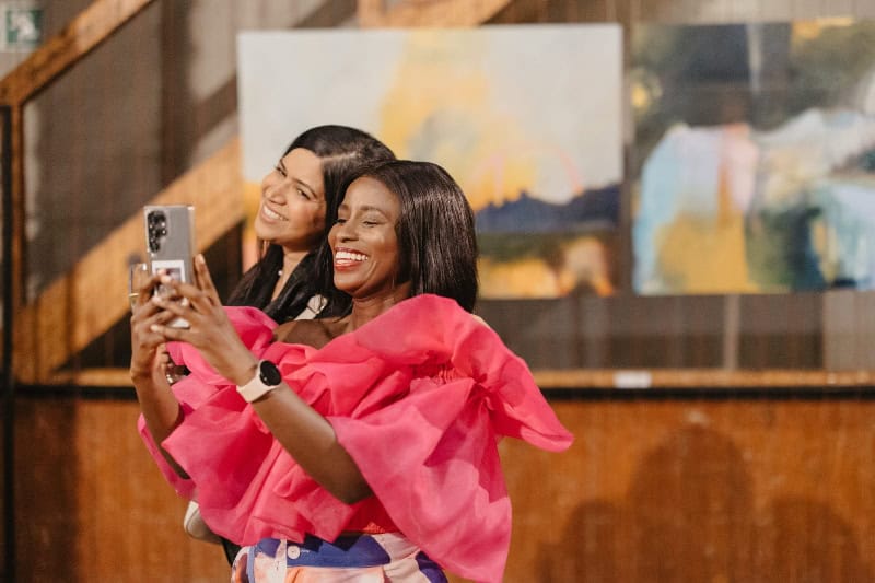 Women enjoying art exhibition at Ava Gallery during Nando’s Creative Exchange event.