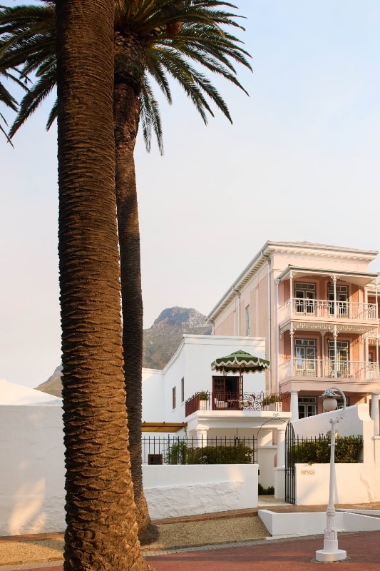 Iconic Mount Nelson Hotel with palm trees in Cape Town, South Africa.