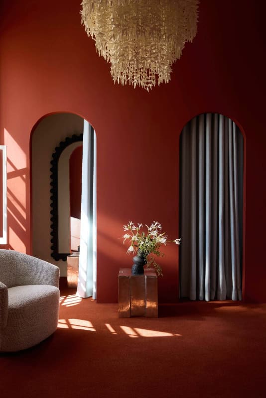 Luxurious hotel room featuring warm lighting, stylish curtains, and contemporary furnishings in Cape.