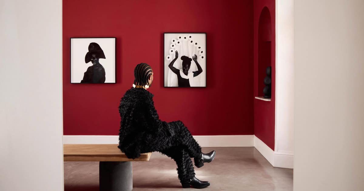 Woman viewing modern art at Mount Nelson Hotel in Cape Town, South Africa.