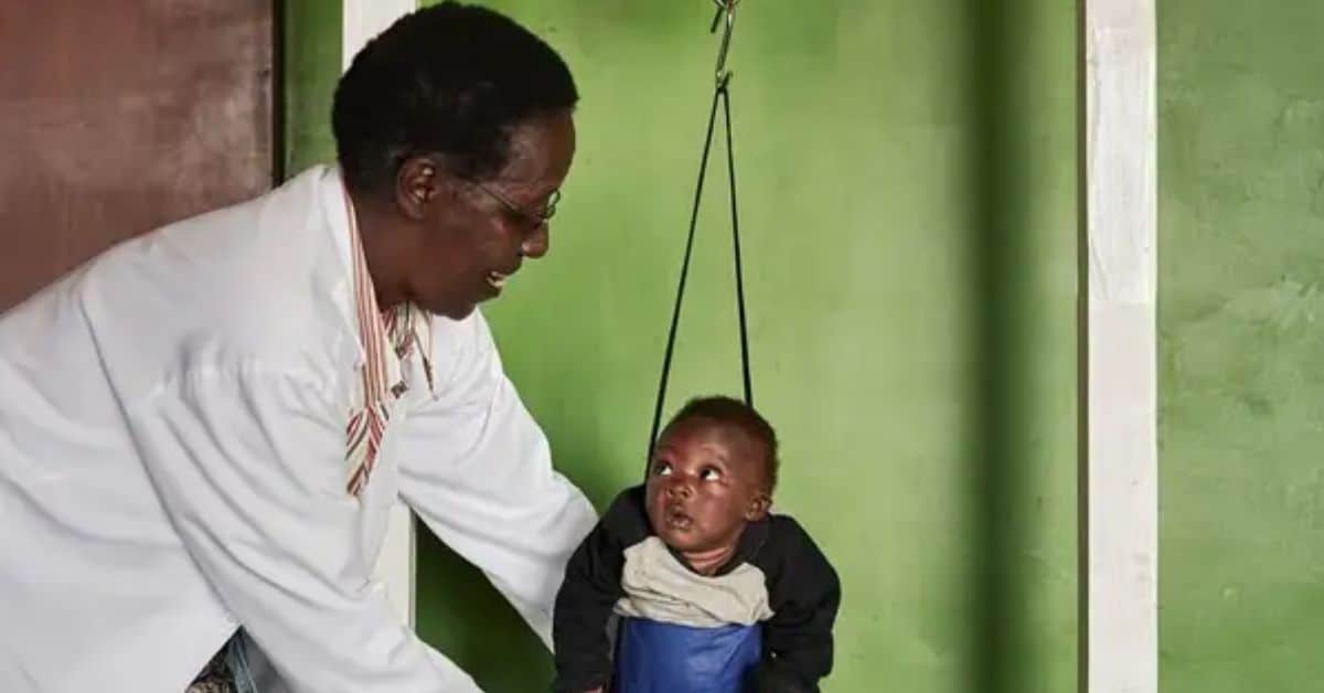 Pediatric healthcare worker examining a young child in Tanzania.