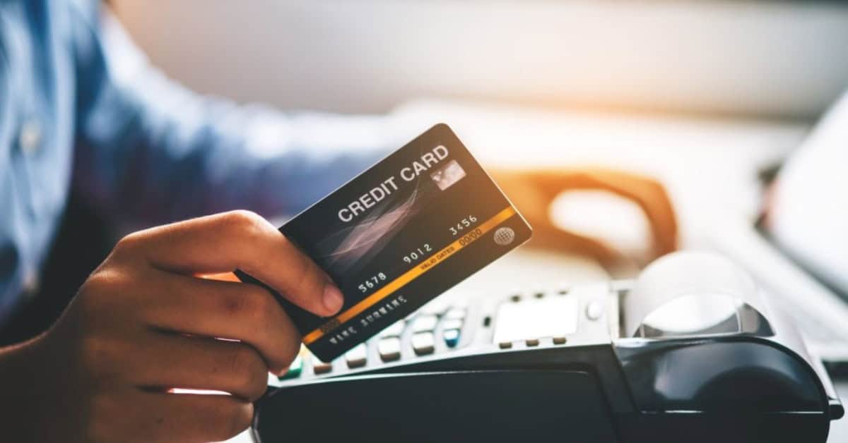 Person using a credit card at a point-of-sale terminal in Africa.