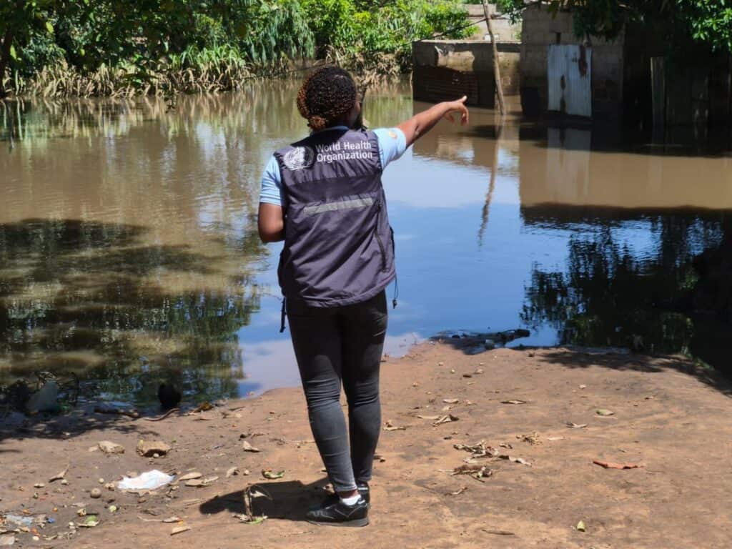 Woman from WHO team inspecting floodwaters in Mozambique disaster zone.