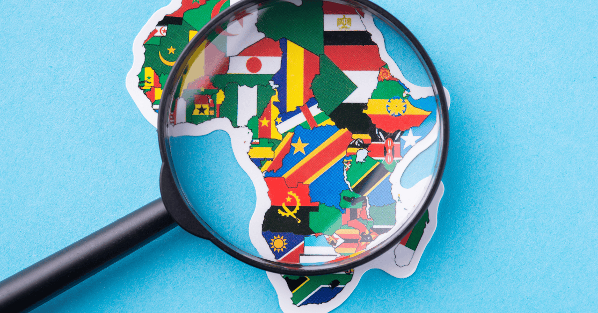 Magnifying glass over Africa map with national flags, highlighting Africa’s $155 billion borrowing s.