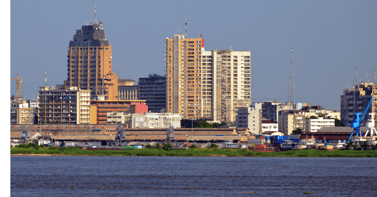 Urban skyline with high-rise buildings near a river in the Democratic Republic of Congo.