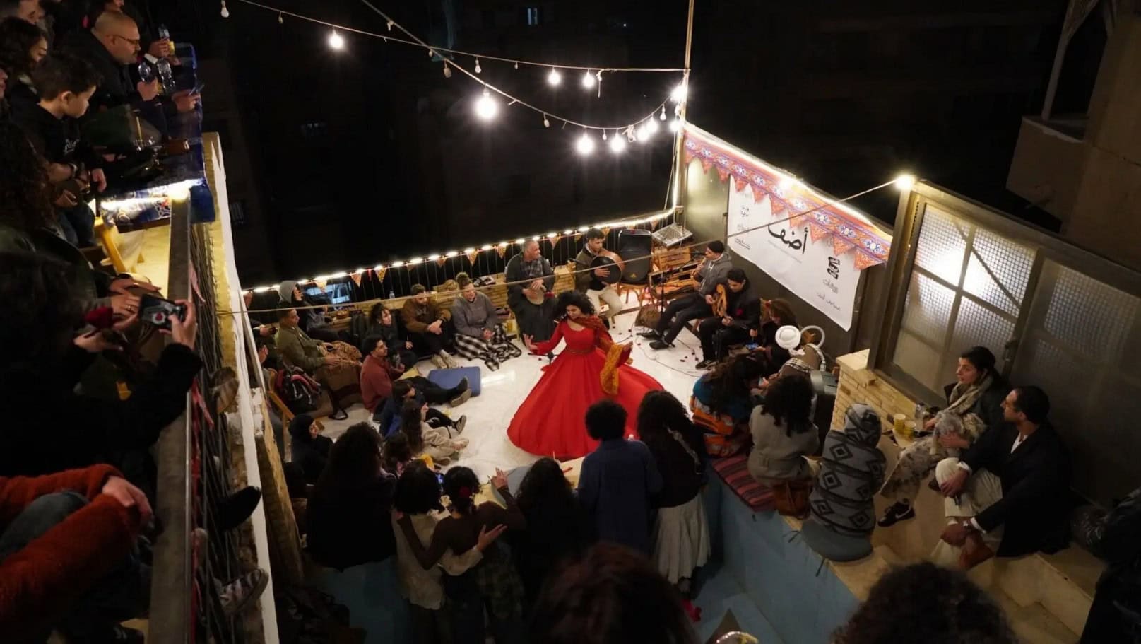 Vibrant African cultural event with traditional dance and music at night.