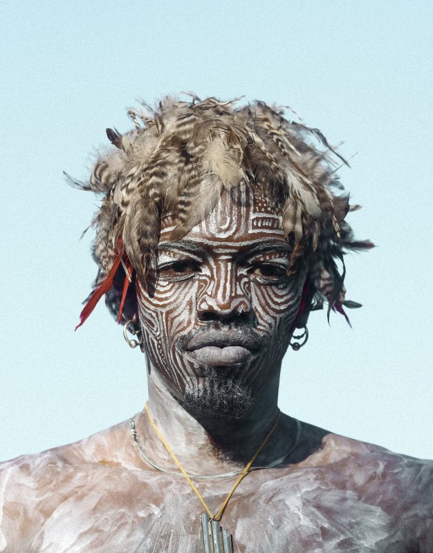 African man with traditional face paint and hairstyle, celebrating jazz music in Cape Town streets.
