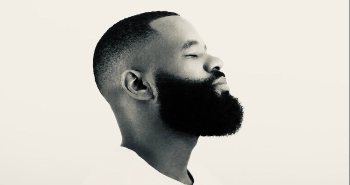Epic Minds producer with a focused expression and beard, highlighting creativity in African music.