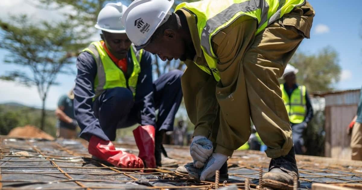 Construction workers building a house for global housing solutions.