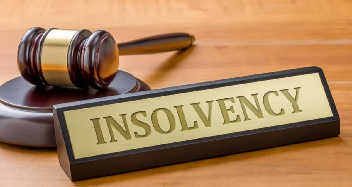 Gavel and "Insolvency" sign symbolizing financial distress and legal proceedings.