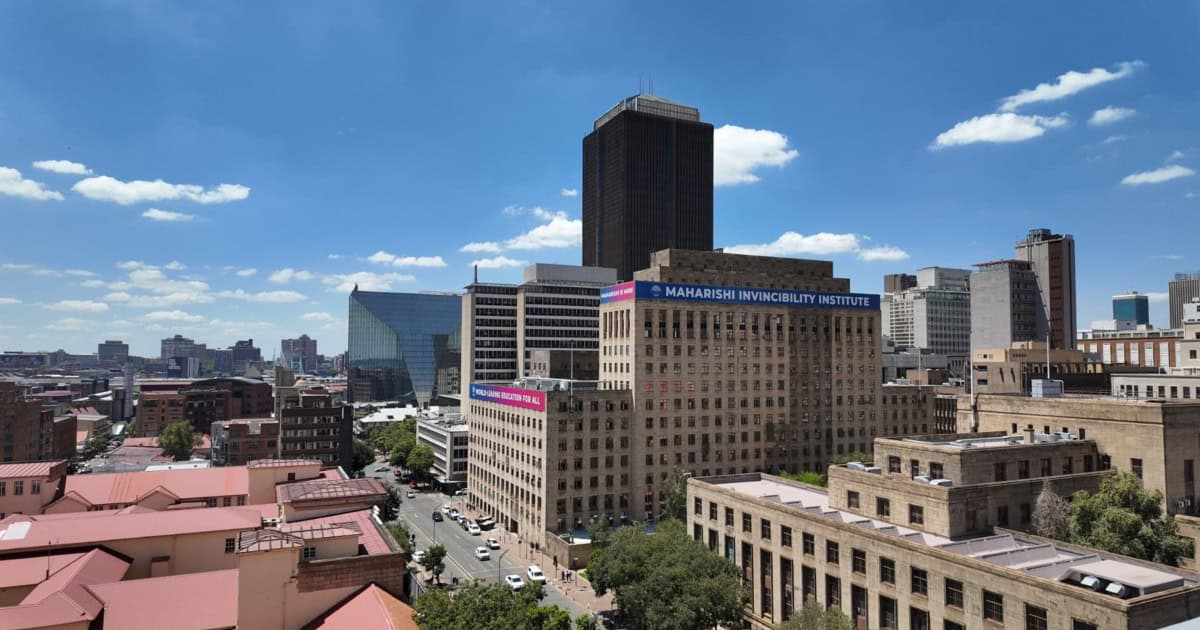 Johannesburg CBD skyline with modern buildings and blue sky, highlighting tech education growth.