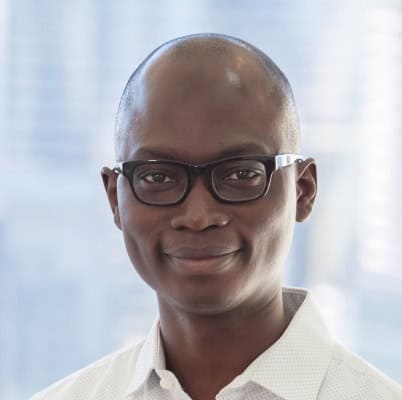 Business professional wearing glasses in an office setting.