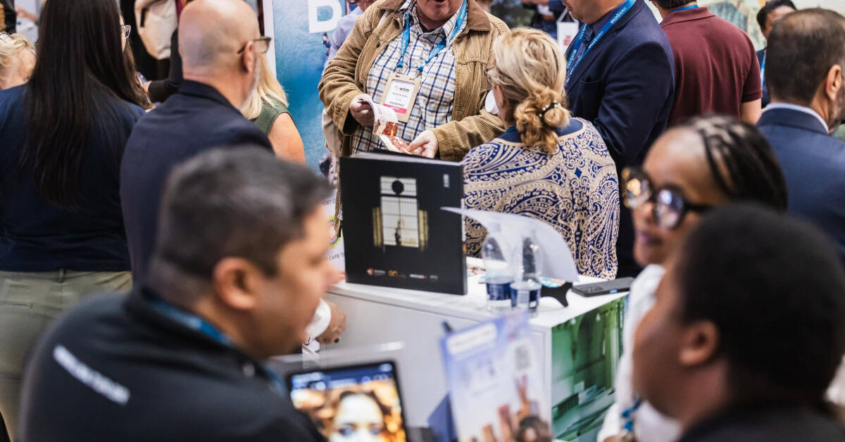 Business professionals networking at Africa Travel Trade Show event.